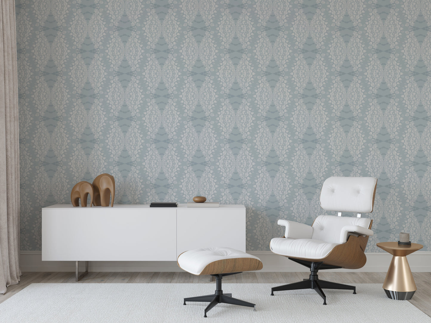 Modern office interior with a white desk, chair, and ottoman against a hand-dyed wallpaper.