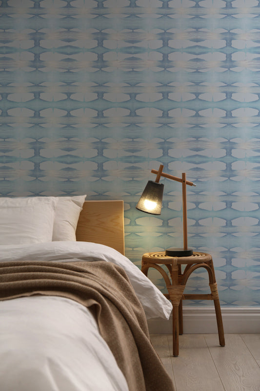 Bedroom with baby blue hand-dyed wallpaper.